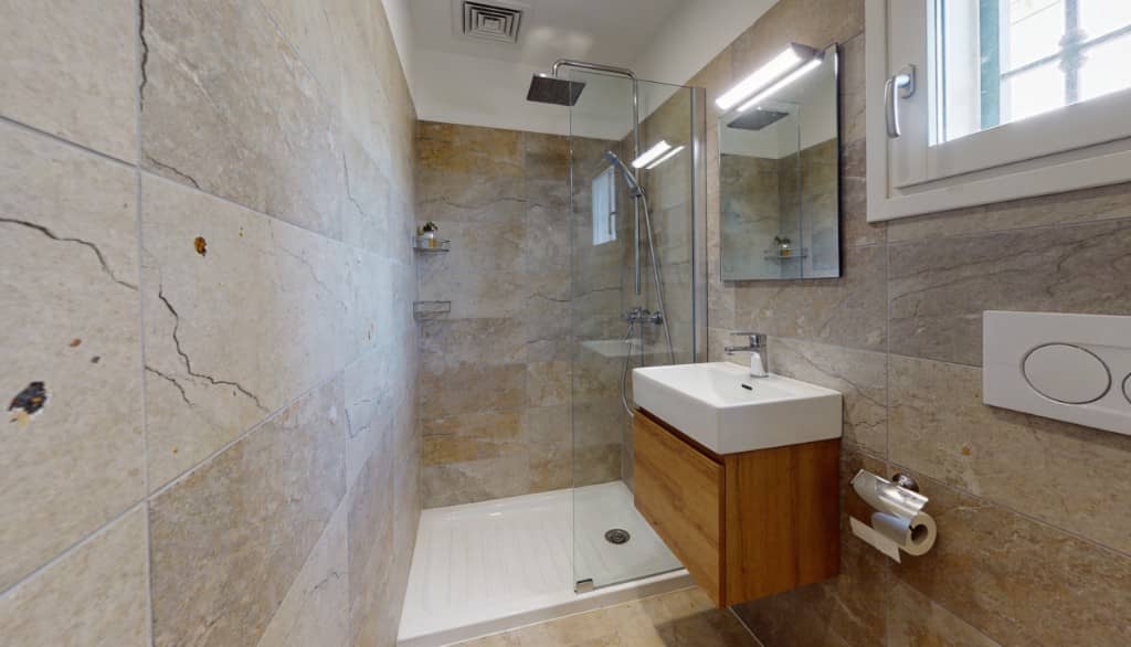 Baño pequeño reformado con mueble suspendido y ducha contemporánea